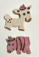 Front view of both ceramic animal pins