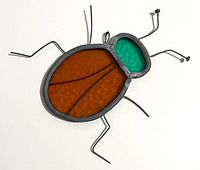 Front view of stained glass beetle showing colors and shape