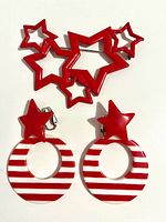 Brooch and both clip-on earrings on white background