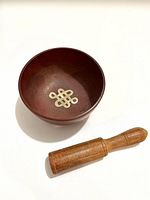 Bowl interior showing eternal knot motif and striker