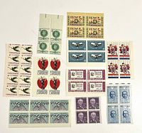 Front view of eleven uncirculated U.S. stamp plate blocks showing different designs and denominations