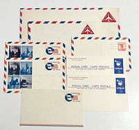 Front view of assorted envelopes and postal cards displaying printed postage designs