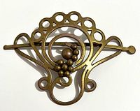Front view of brass barrette showing design and bead cluster
