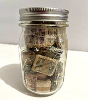 Full view of jar front showing Ball embossing and stamp bundles inside