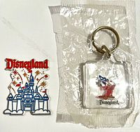 Keychain sealed in plastic beside castle magnet front view