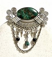 Front view showing stone, design, chains, dangles