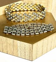Both bracelets displayed together on stand