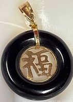 Front view showing gold fu character within black onyx ring