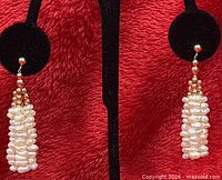Front view showing both pearl tassel earrings on display stand