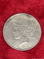 Obverse of 1928 Peace Dollar on red background
