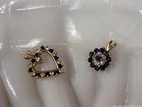 Both pendants front view showing design and stones