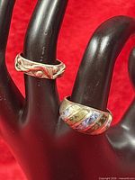 Two sterling silver rings on display hand