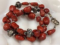 Close-up of coral beads, silver spacers and clasp