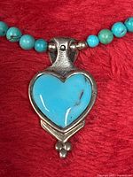 Close-up of turquoise heart pendant and bead strand
