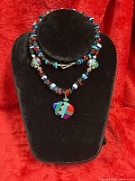 Necklace doubled on bust showing beads and central inlay buffalo pendant