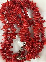 Close-up of red coral branch beads and sterling clasp