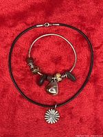 Necklace and bracelet laid flat on red fabric