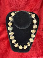 Necklace on display bust showing overall design and bead shape