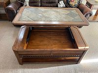 Coffee table with lid raised showing storage compartment and lift hinges