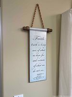 Front view of metal wall scroll with faith verse showing cord hanger and finials