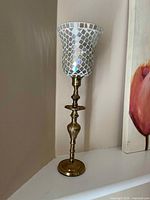 Full view of candle holder showing gold stem and mosaic glass shade