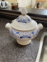 Front view of tureen with lid showing floral pattern and handles