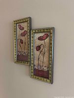Two matching framed floral prints hung on wall