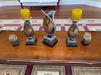 Front view of all five matching leaf motif candle holders and centerpiece