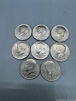 All eight Kennedy half dollars front side visible