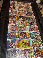 Overhead view of roughly 30 individually bagged Conan issues laid out showing cover art and issue number range