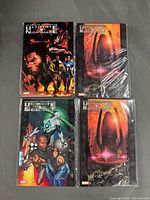 Front covers of four graphic novels in sleeves