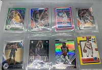 Eight sleeved NBA rookie/parallel cards in two-row layout