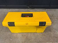 Closed yellow toolbox showing exterior condition and brand label