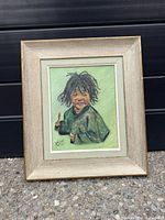 front view of framed child portrait painting
