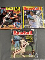 Front covers of all three sticker albums