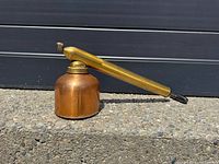 Left side view showing copper reservoir, brass wand, black handle