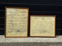 Both framed map prints standing side by side