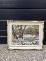 Front view of framed winter landscape painting