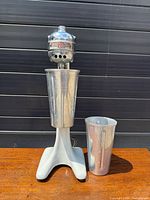 Front view of Hamilton Beach Model 10 mixer with cup attached, second cup beside