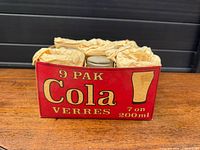 Front view of carrier box filled with wrapped glasses