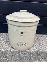 Front view showing crock with lid, capacity mark and overall condition