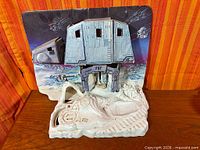 Full view of plastic base and cardboard backdrop