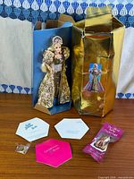 Lot overview showing doll in inner sleeve, outer box, accessories, paperwork