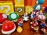 Group view of Nintendo toys showing mushrooms, blocks and karts