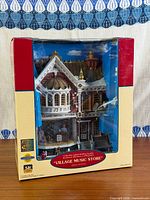 Front view of boxed Lemax Village Music Store building