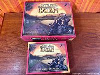 Base game and extension boxes on table