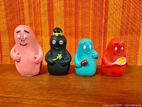 Front view of all four Barbapapa figures standing on surface