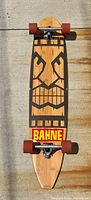Full view of Bahne longboard showing deck graphic, trucks and wheels