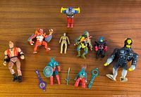 Group shot of all nine action figures and four accessories
