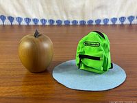 Mini Nintendo backpack beside apple for scale